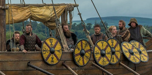 Viking warriors on the Viking ships. They arranged the Viking shields on the sides of their ship